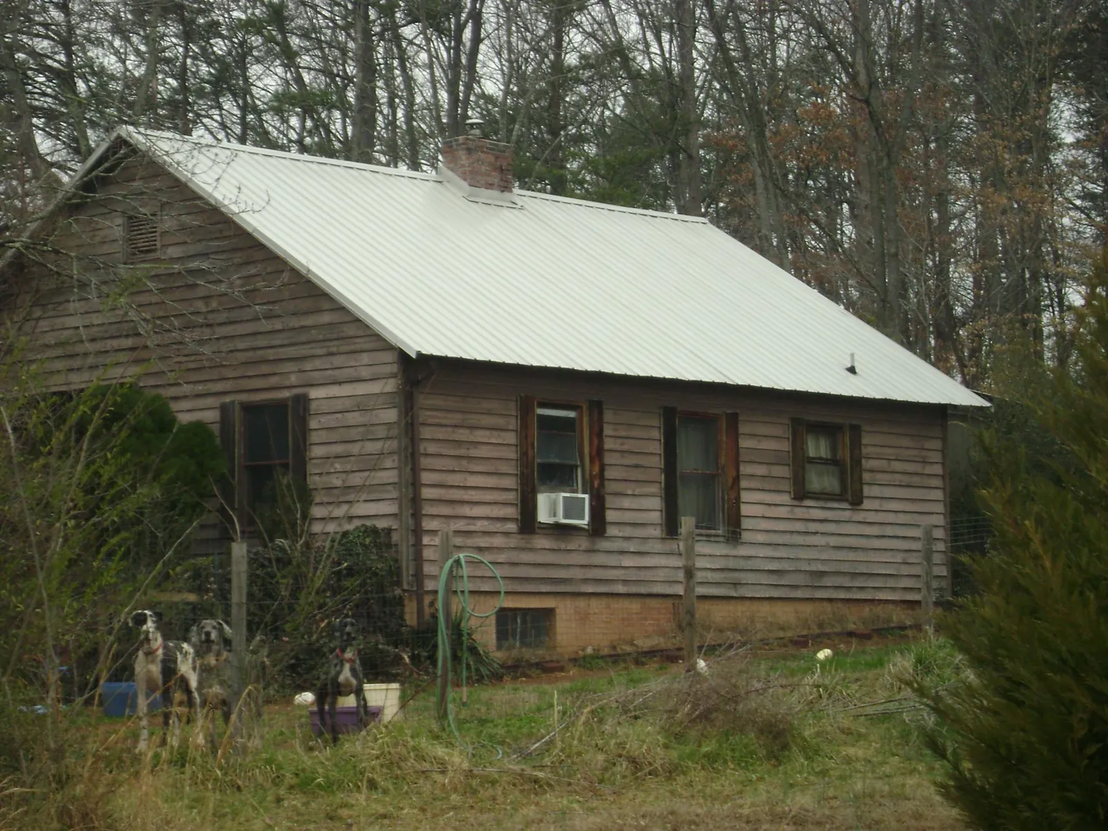 White metal roof on an old wood sided farmhouse, from a Metal Roof Installation job in Belgrade