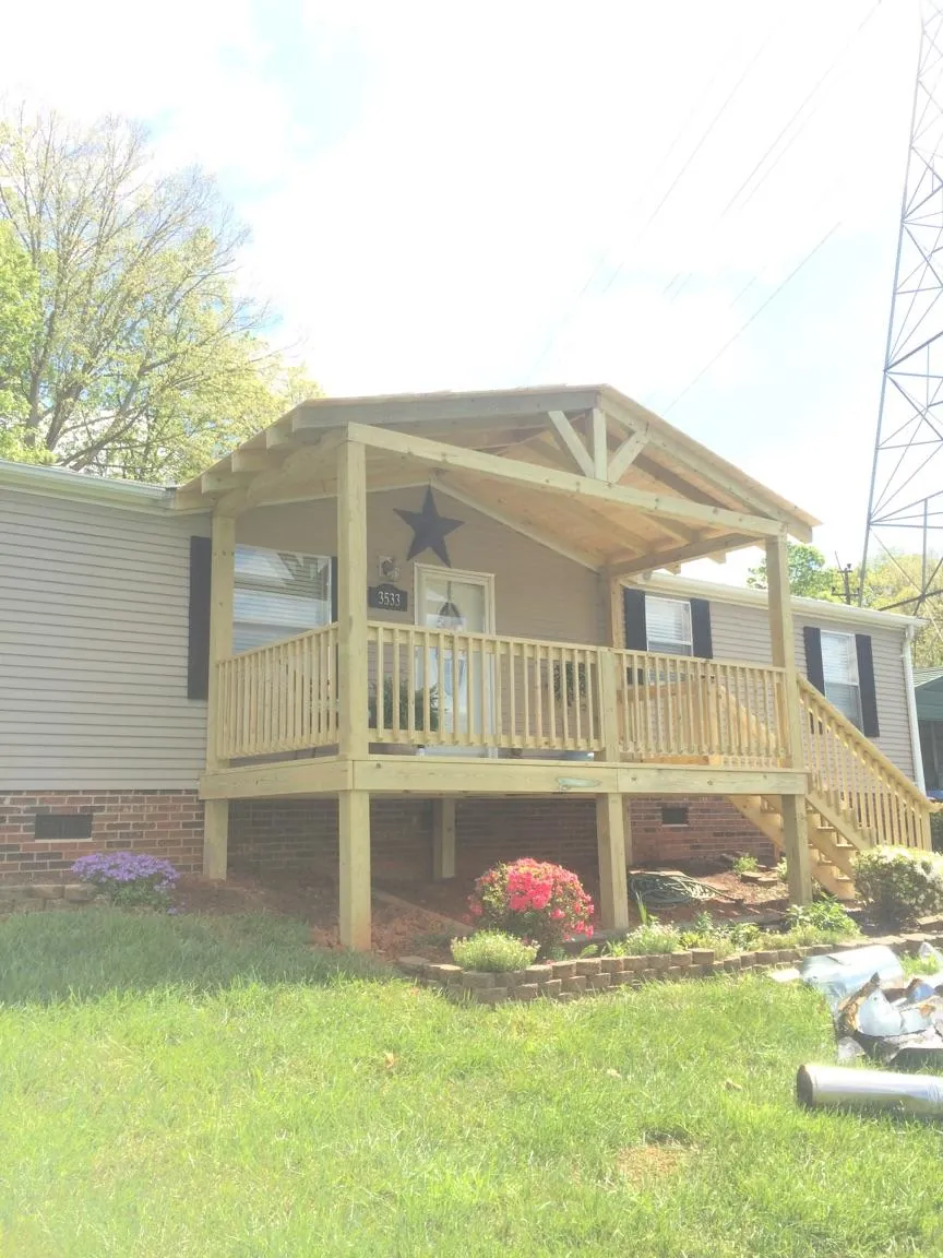 New gabled porch roof and deck railing added to a ranch home in Belgrade